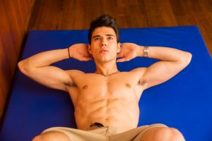 handsome-young-man-doing-abs-exercises-on-mat-640x426